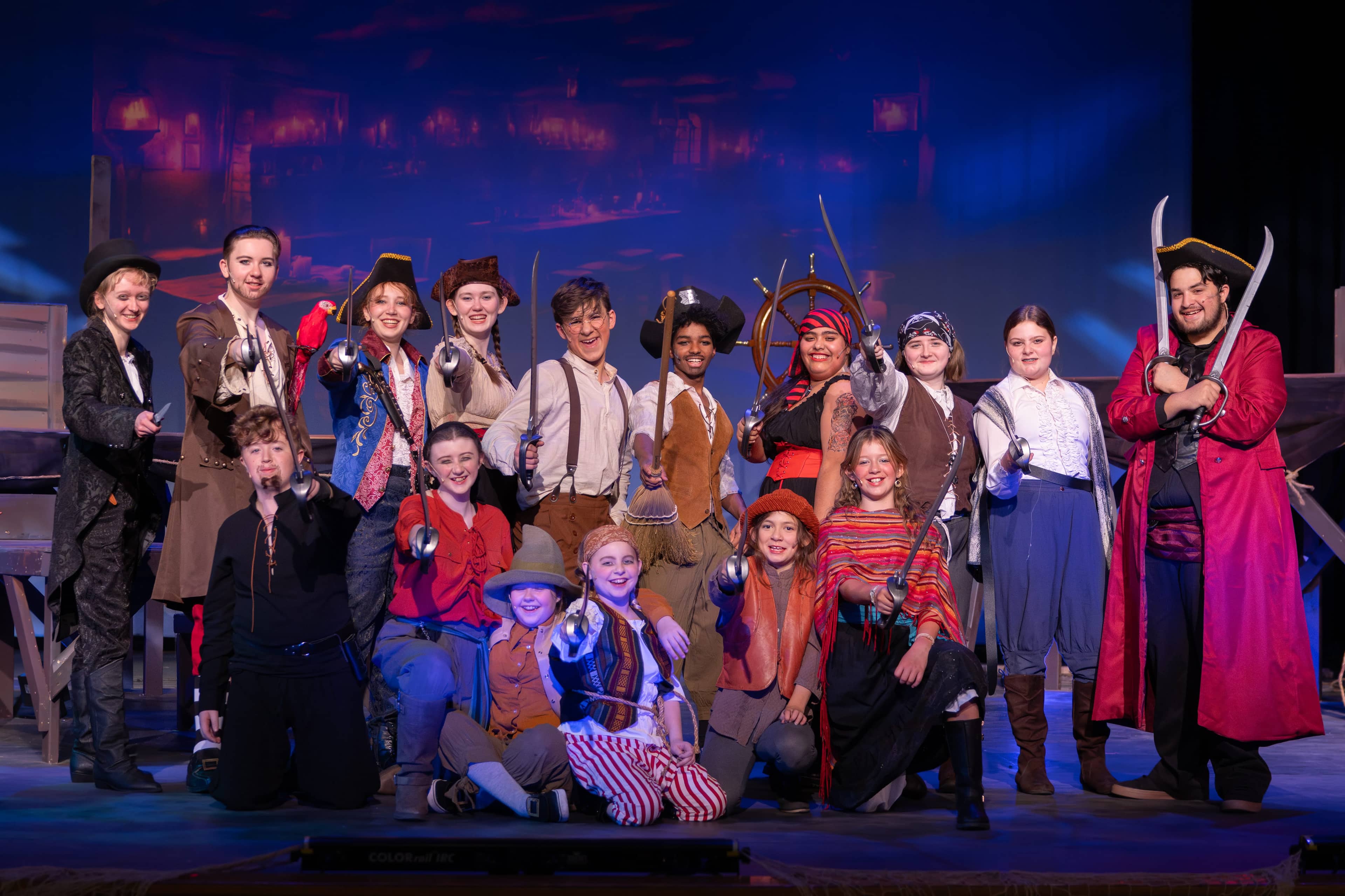 Cast of Treasure Island posed together in costume onstage in fall 2024