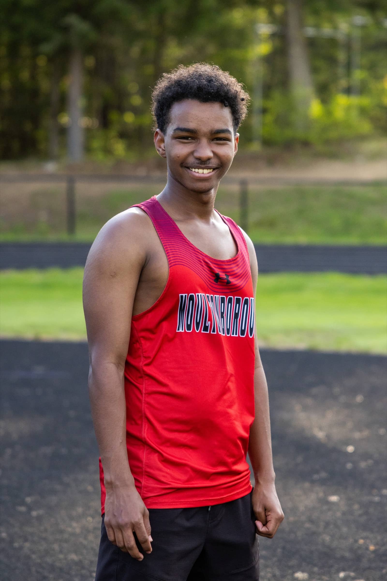 Moultonborough Academy track athlete posing in uniform