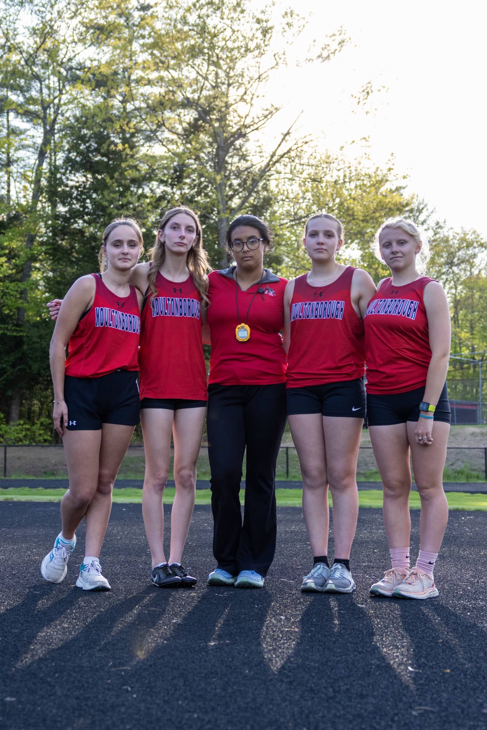 Moultonborough Academy track athletes and coach gathered after the meet