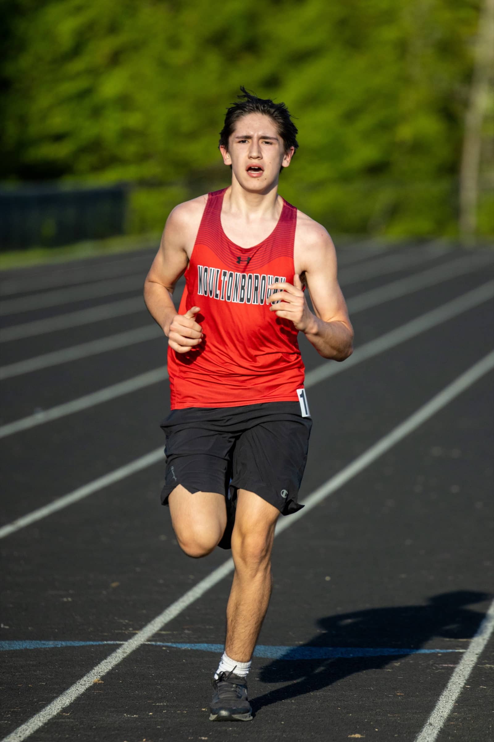 Moultonborough Academy distance runner competing on the track