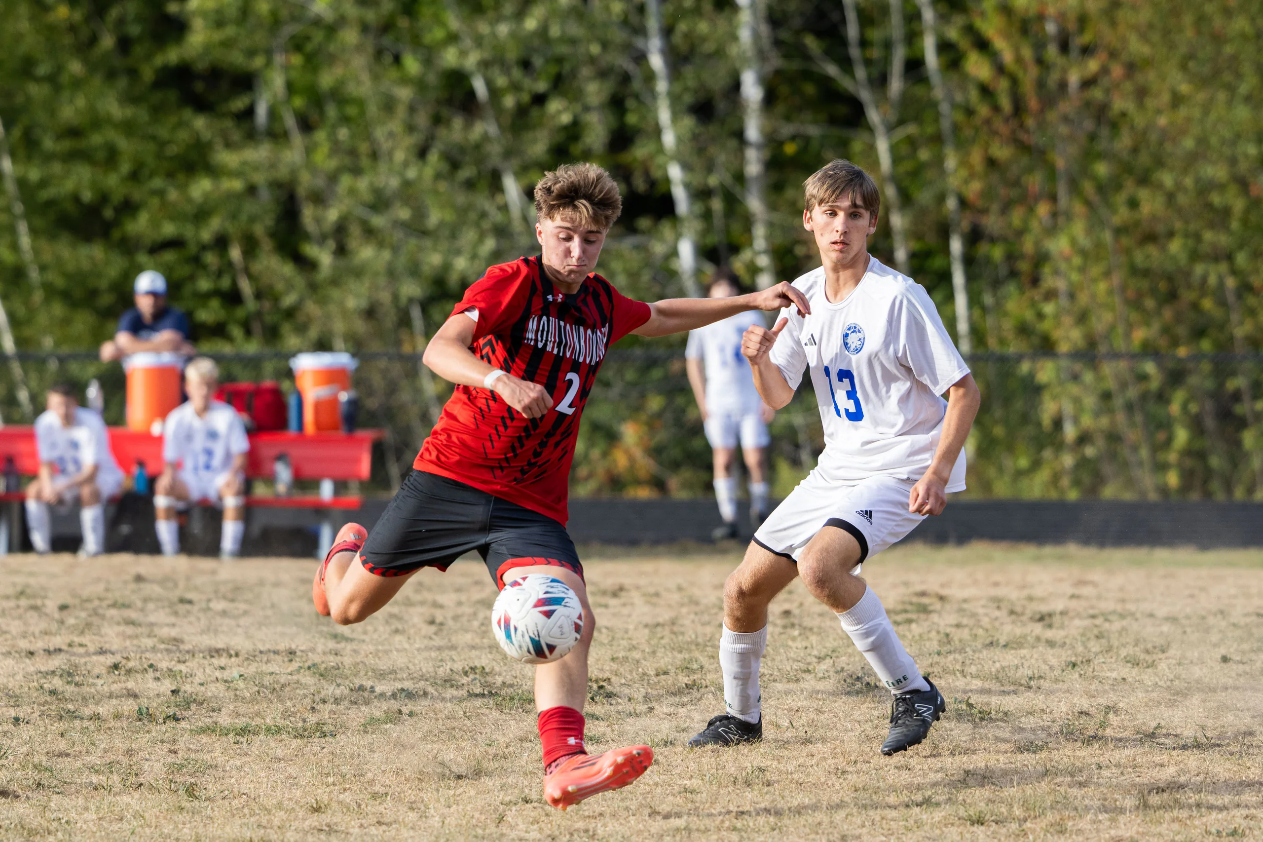 High school soccer players competing for the ball