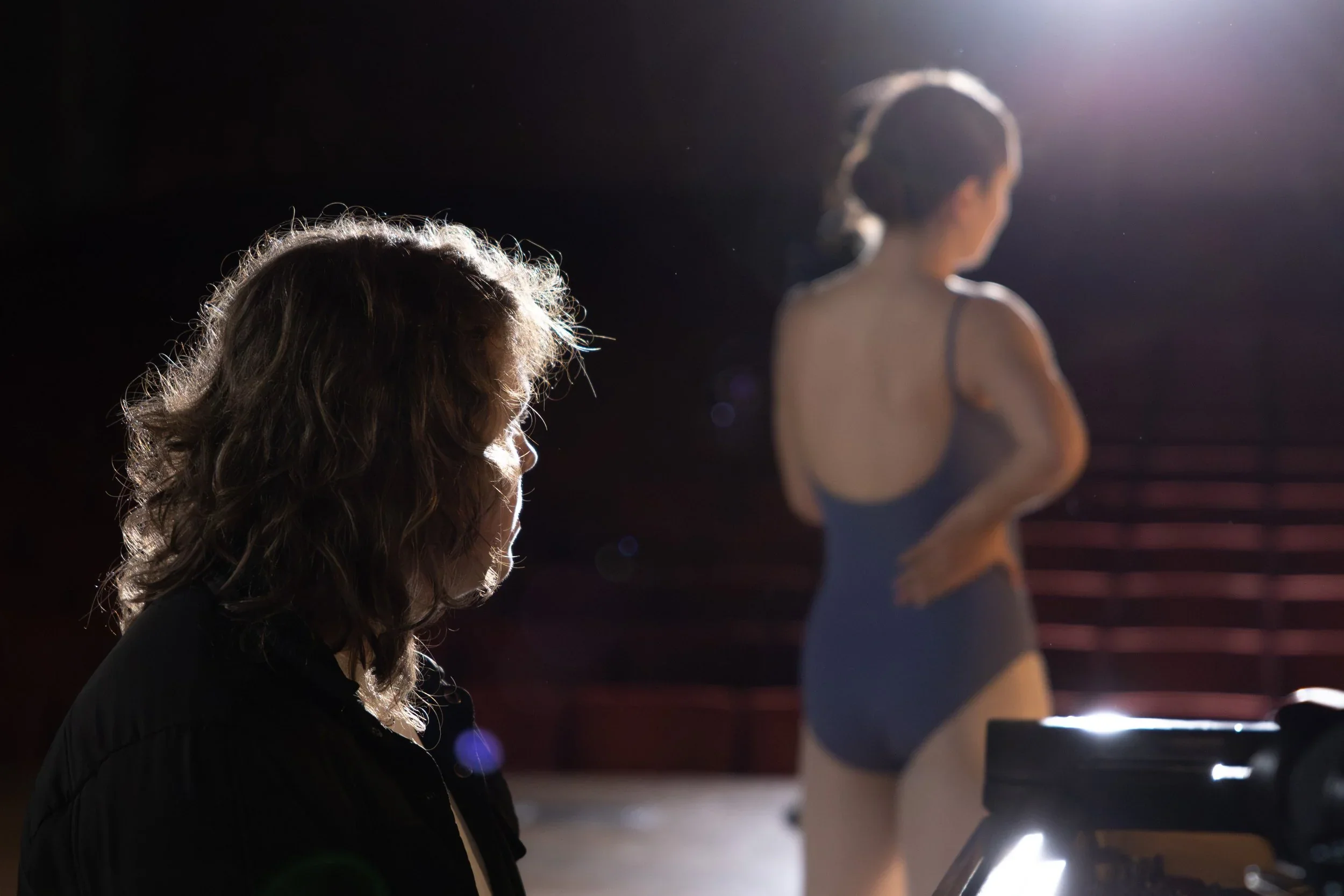 A performer and crew member lit on the set of Harmony of Hearts